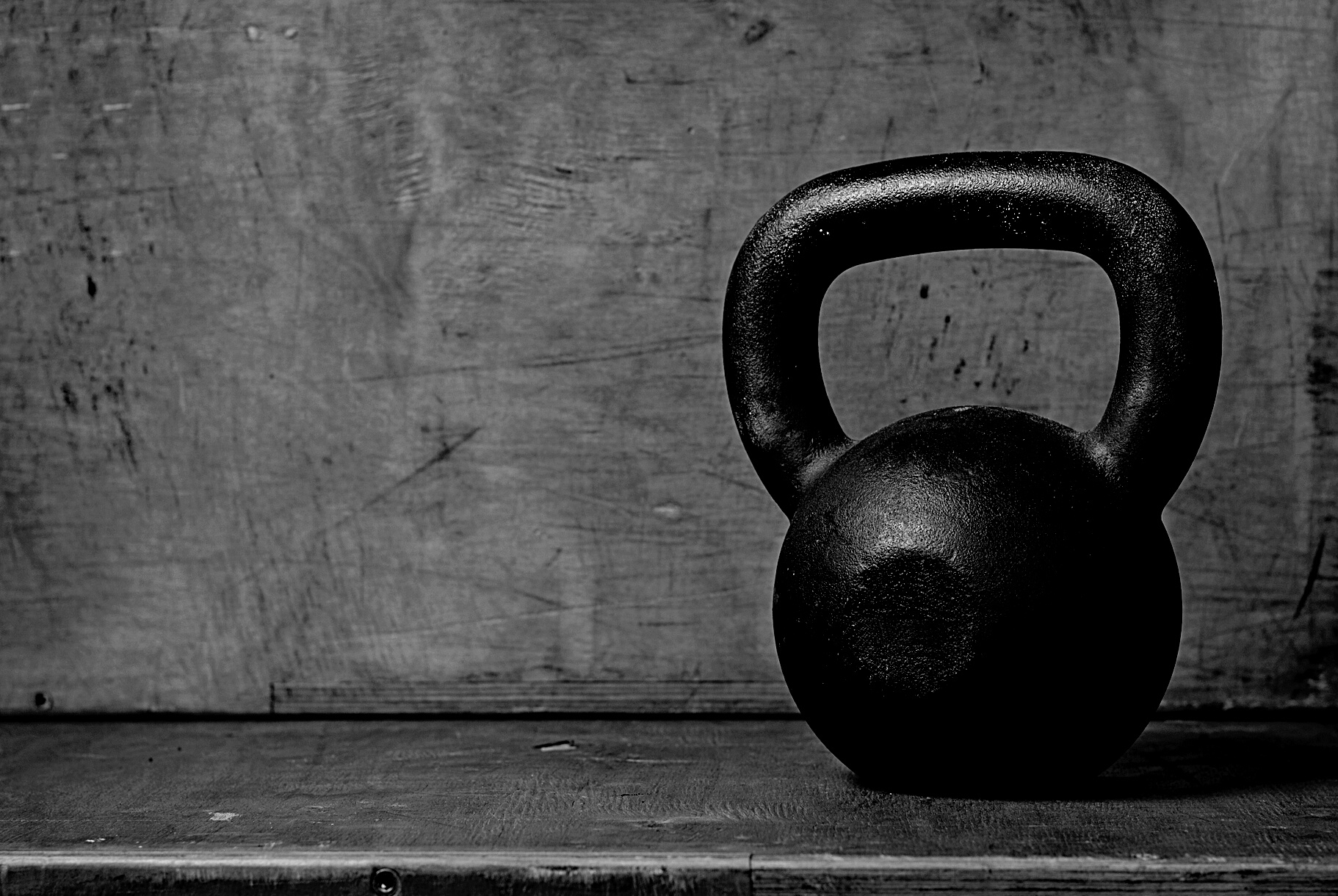 kettlebell in black on wooden background
