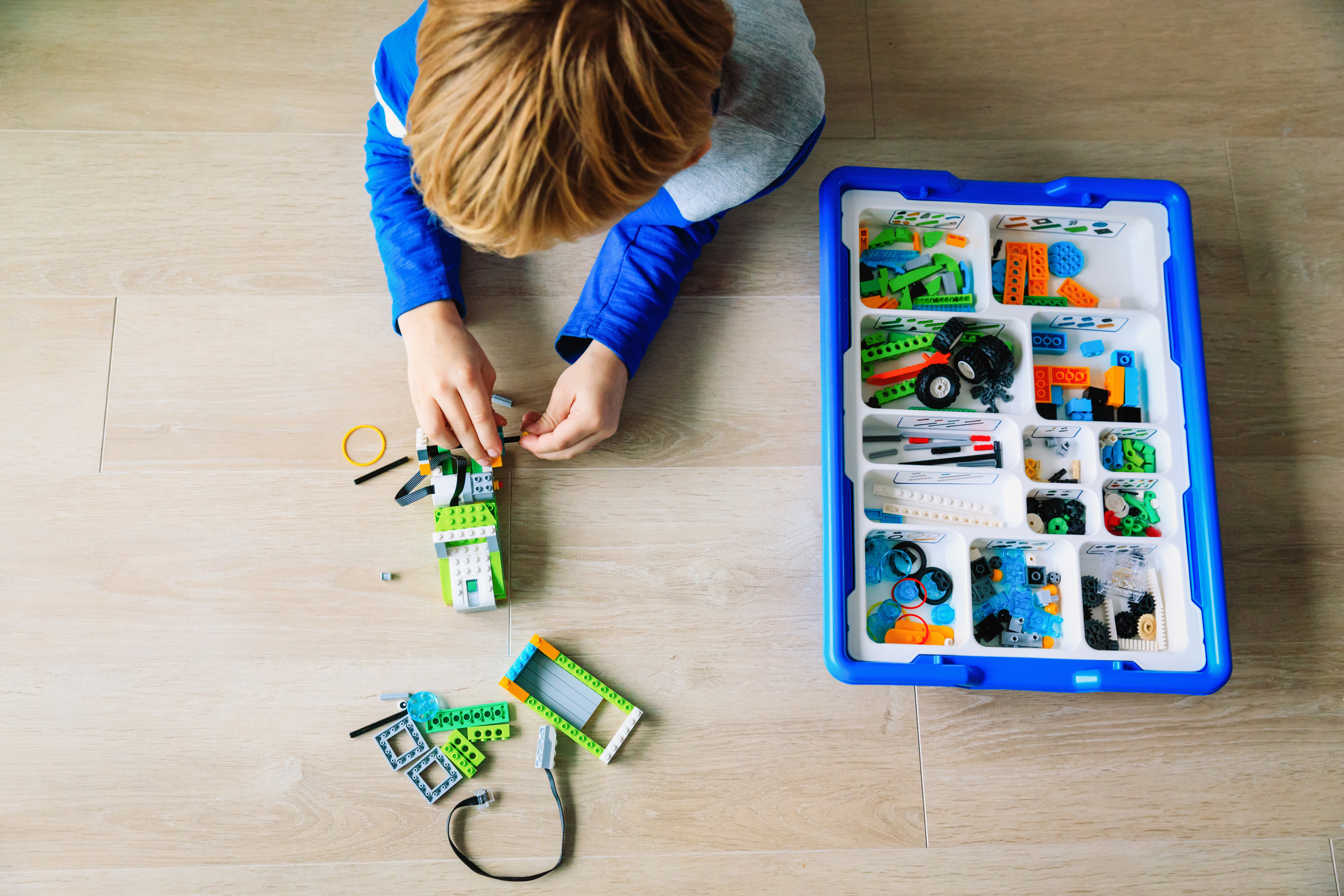 boy building robot at robotic technology school lesson